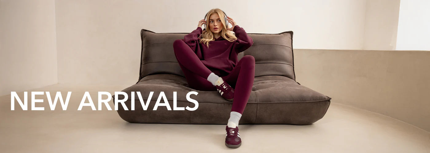 Woman sitting on a modern brown sofa with 'NEW ARRIVALS' text overlay.